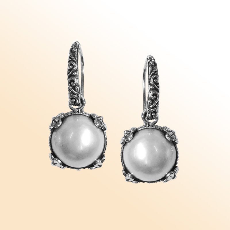 Sterling silver artisan crown-frame Mabe Pearl drop earrings with ornate detailing and earwire lock.