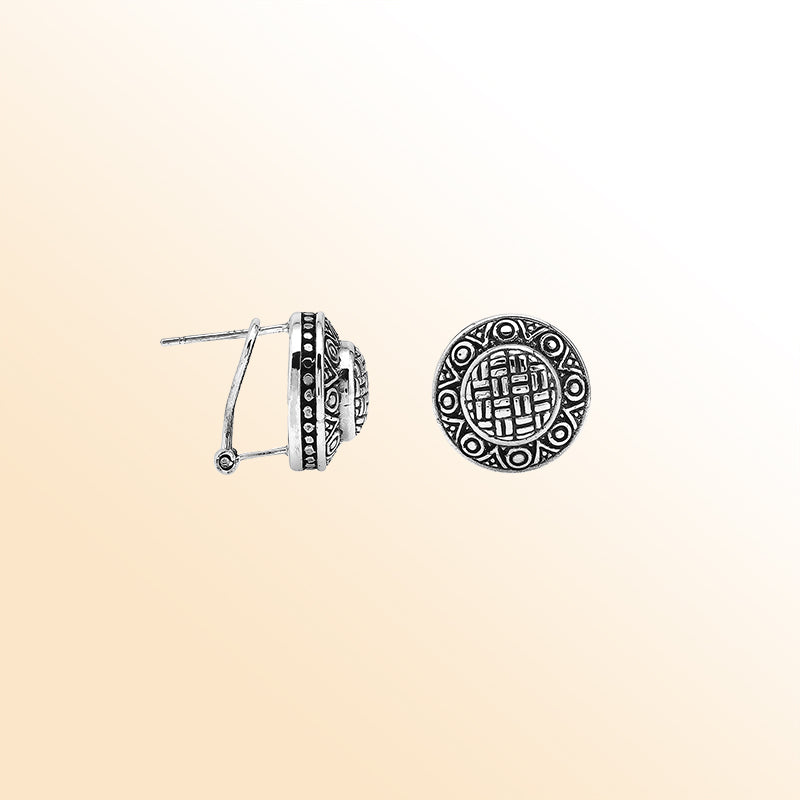 Sterling silver artisan round earrings with carved geometric pattern and omega clip closure.