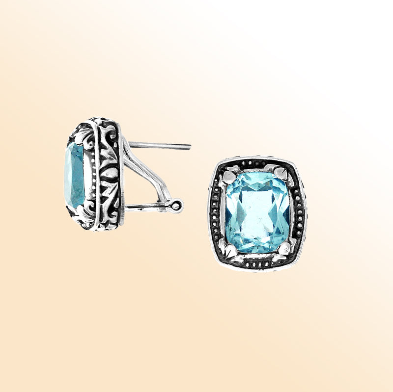 Sterling silver artisan earrings with Blue Topaz Quartz in a cushion frame and omega clip closure.