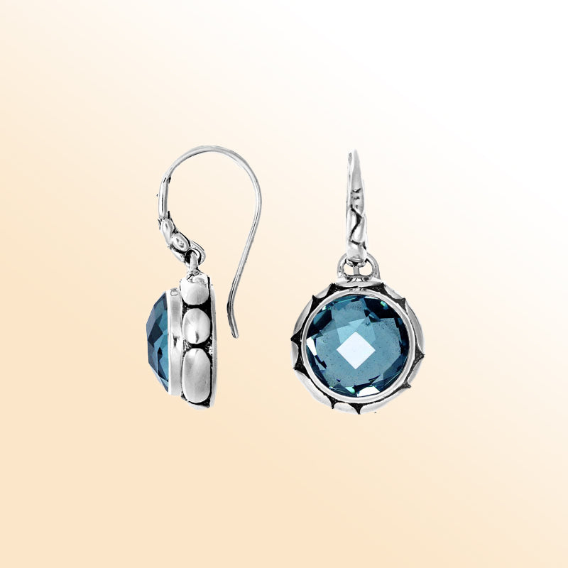 Sterling silver artisan earrings with round Blue Topaz Quartz and sculpted bezel detailing.