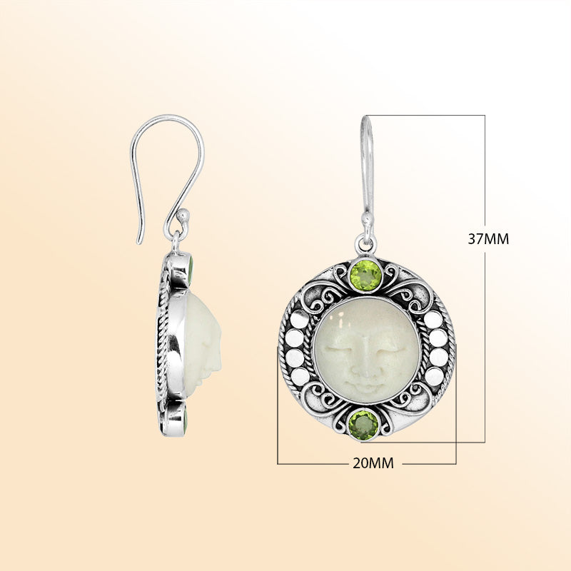 Sterling silver earrings with serene bone face carving and Peridot Quartz accents.