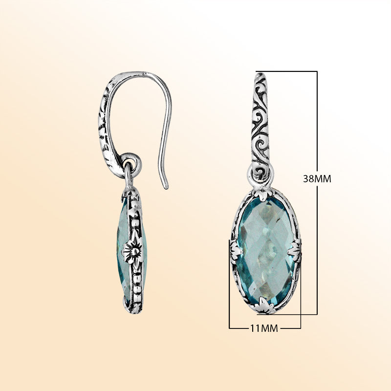 A stunning pair of 925 sterling silver earrings featuring oval Blue Topaz Quartz stones with Balinese floral detailing and earwire hooks for a modern elegant look.