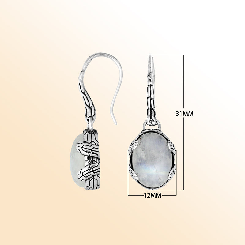 Handcrafted sterling silver Rainbow Moonstone oval drop earrings with antique oxidized texture and celestial glow.