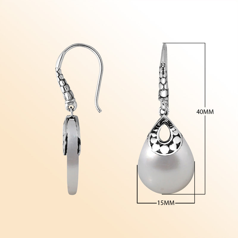 Handcrafted sterling silver Mother Of Pearl pear-drop earrings with antique oxidized finish and elegant Balinese design.