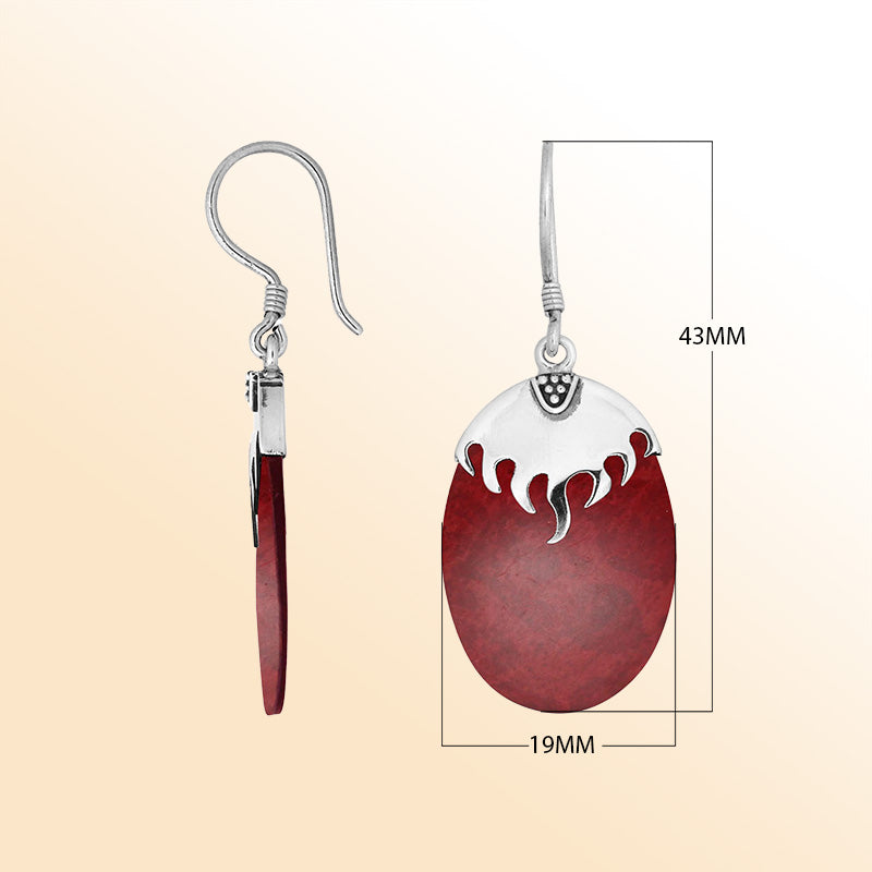 Artisan sterling silver earrings with Red Coral ovals and a flame-inspired sculpted silver cap.