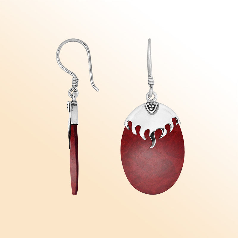 Artisan sterling silver earrings with Red Coral ovals and a flame-inspired sculpted silver cap.