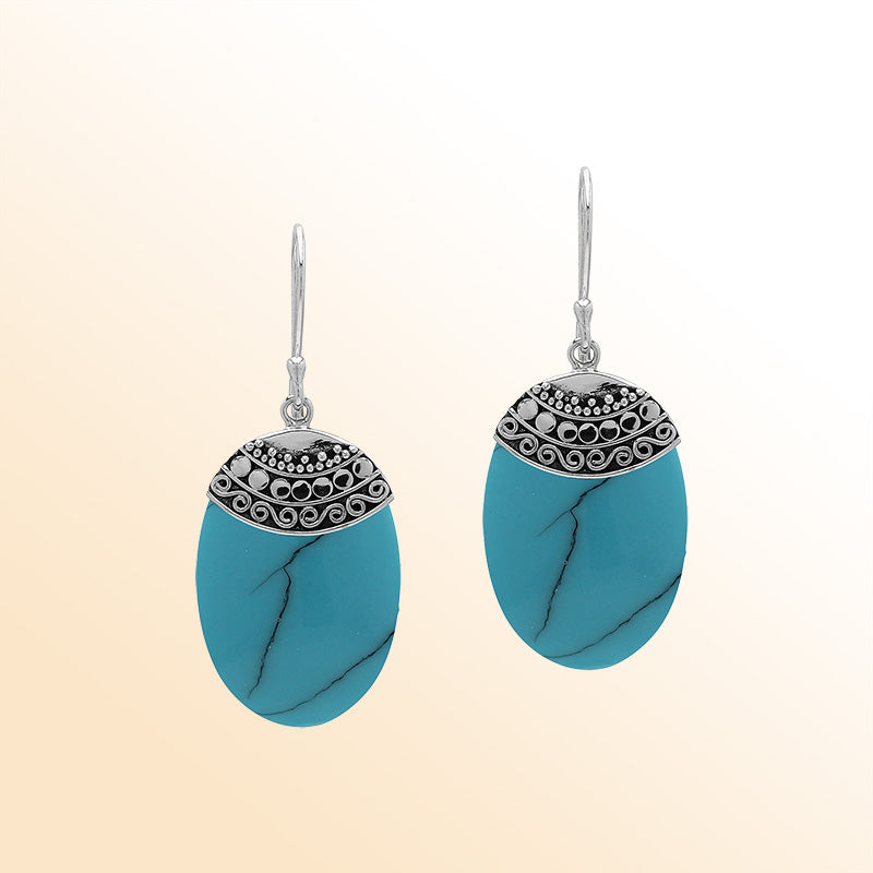 Artisan sterling silver earrings with Turquoise Shell ovals and a decorative ornate patterned silver cap.