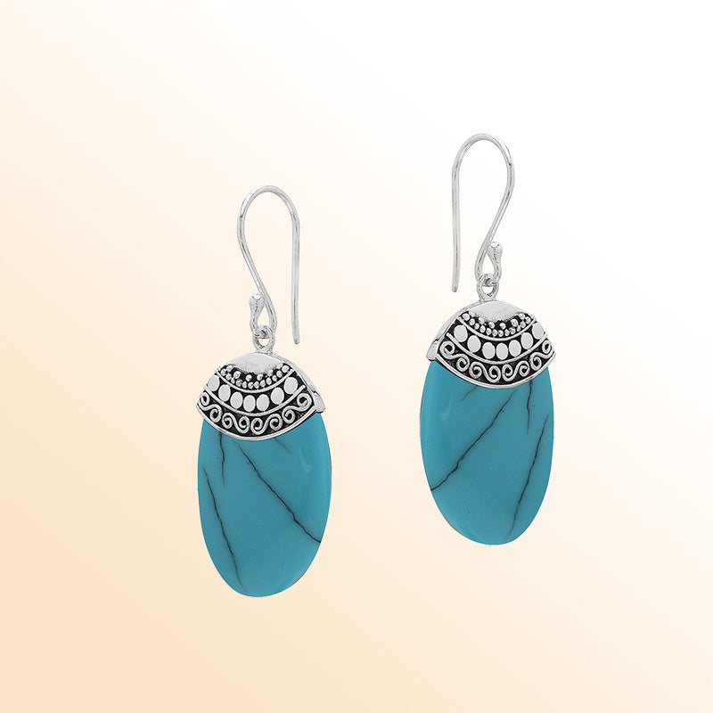 Artisan sterling silver earrings with Turquoise Shell ovals and a decorative ornate patterned silver cap.