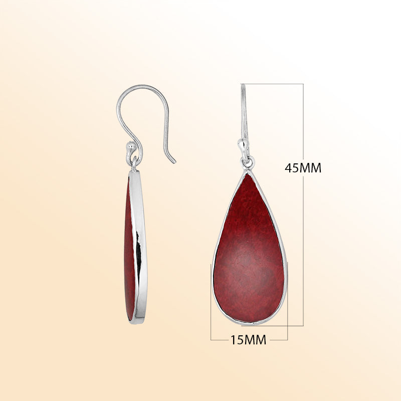 Artisan sterling silver earrings with warm Red Coral teardrops set in sleek polished bezel frames.