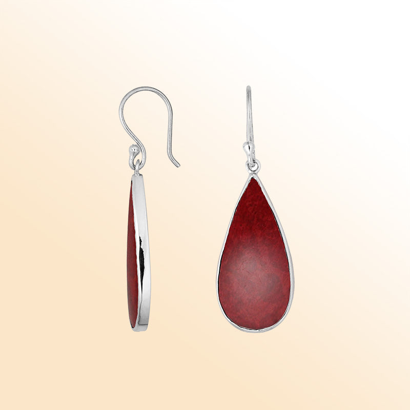 Artisan sterling silver earrings with warm Red Coral teardrops set in sleek polished bezel frames.