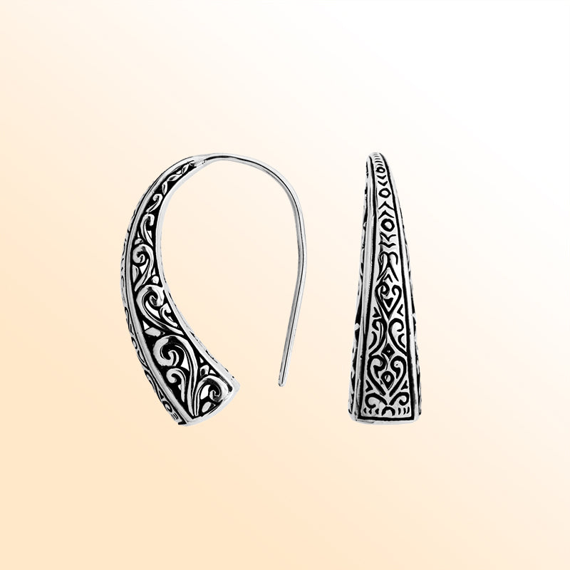 Artisan sterling silver curved tapered earrings with scroll and geometric oxidized detailing.