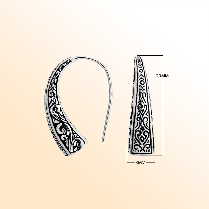 Artisan sterling silver curved tapered earrings with scroll and geometric oxidized detailing.