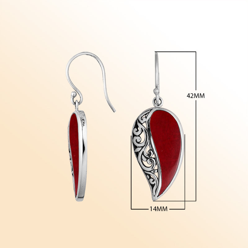 A stunning pair of 925 sterling silver earrings featuring teardrop Red Coral stones with detailed Balinese filigree design and secure earwire hooks for women.