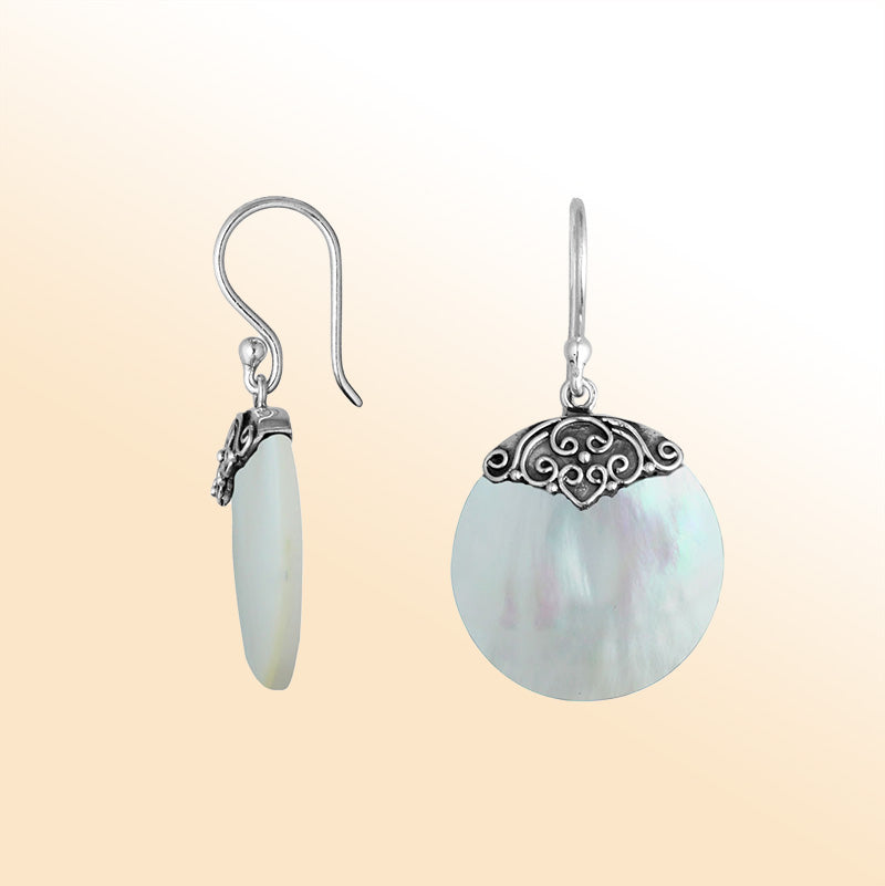 Artisan sterling silver round earrings showcasing glowing Mother Of Pearl with polished handcrafted silver detailing.