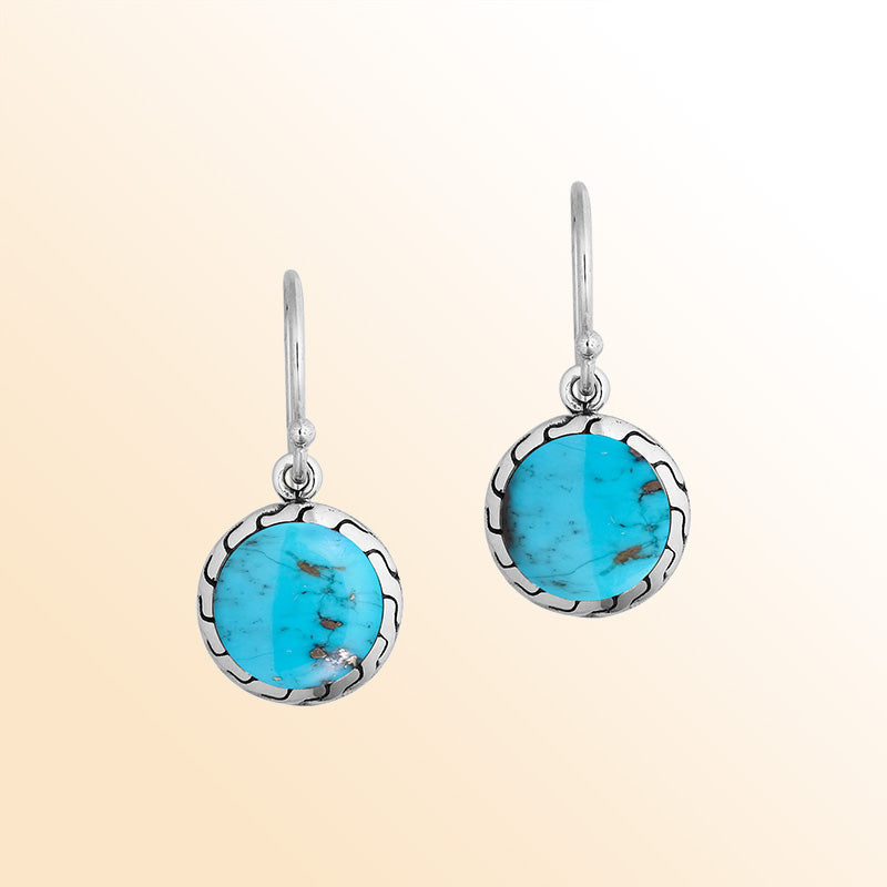 Sterling silver earrings with round Turquoise Shell inlay and polished detailing.