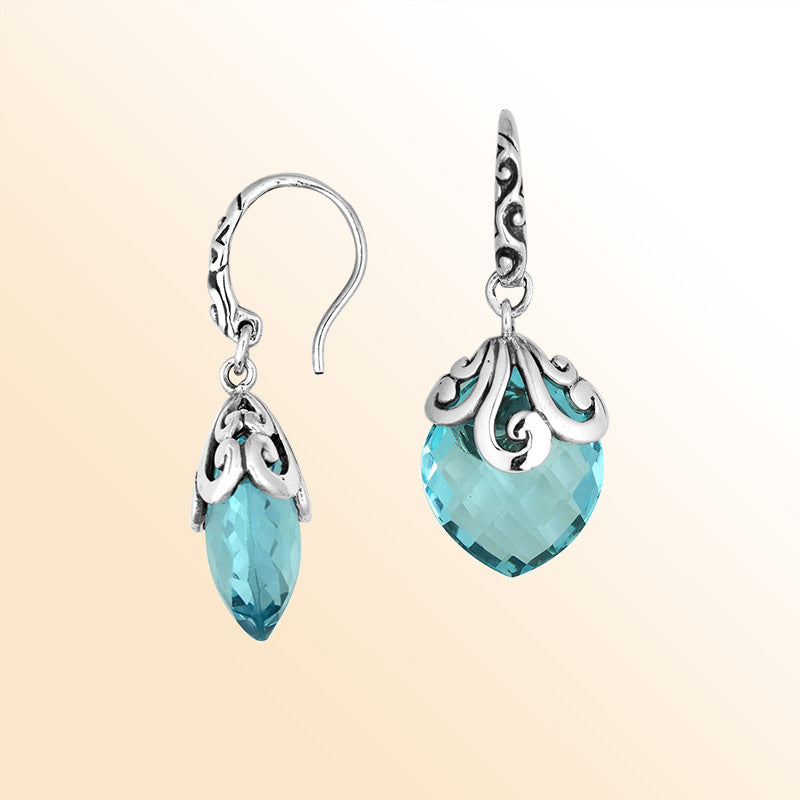 Sterling silver earrings with Blue Topaz Quartz faceted teardrop design and ornate silver detailing.