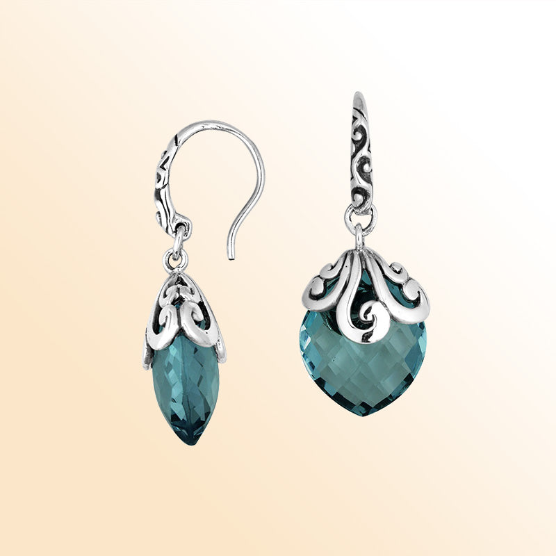 Sterling silver earrings with London Blue Topaz Quartz teardrop design and ornate silver detailing.