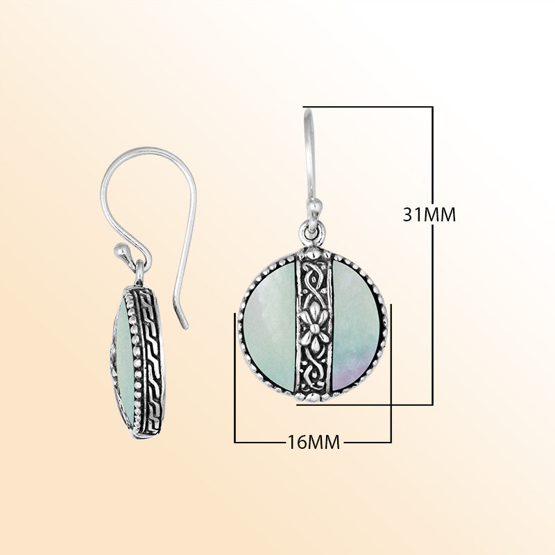 Sterling silver earrings with Mother Of Pearl round design and floral silver detailing.