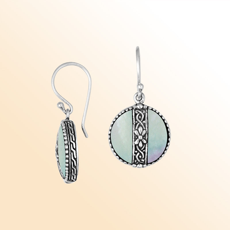 Sterling silver earrings with Mother Of Pearl round design and floral silver detailing.