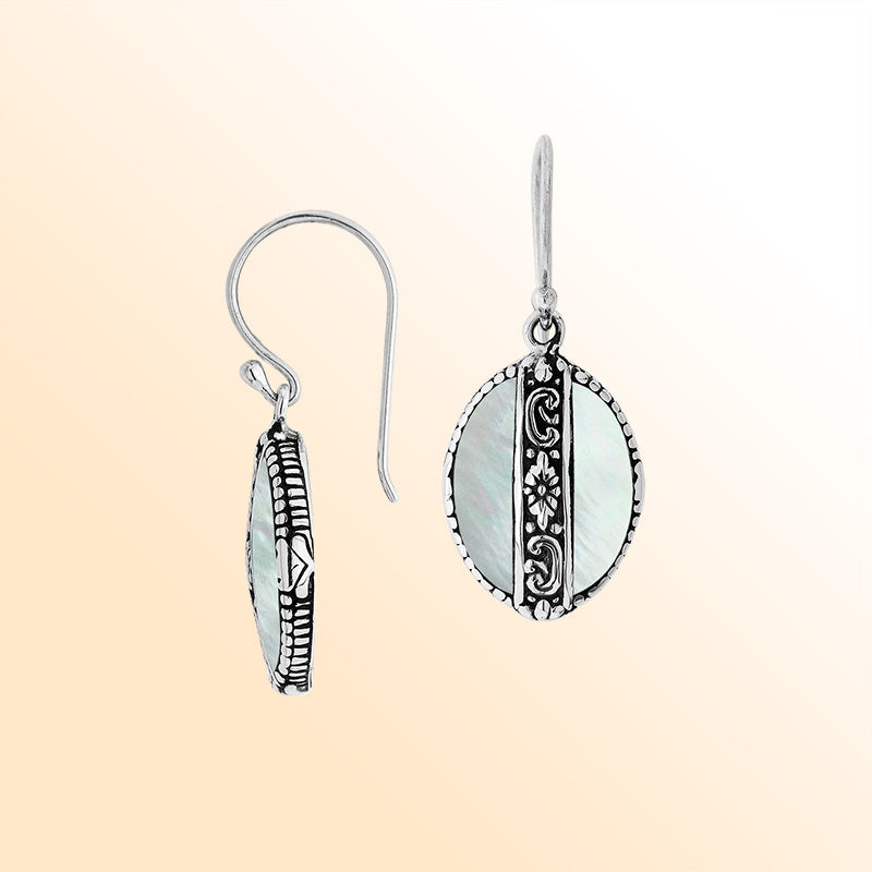 Sterling silver earrings with Mother Of Pearl oval design and floral silver detailing.