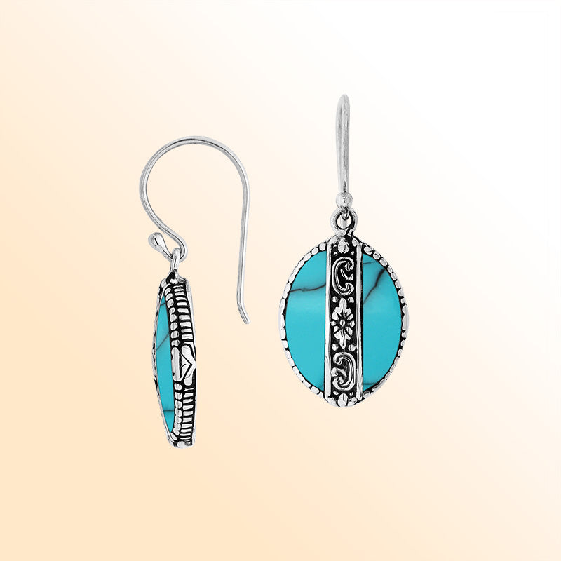 Sterling silver earrings with Turquoise Shell oval design and floral silver detailing.