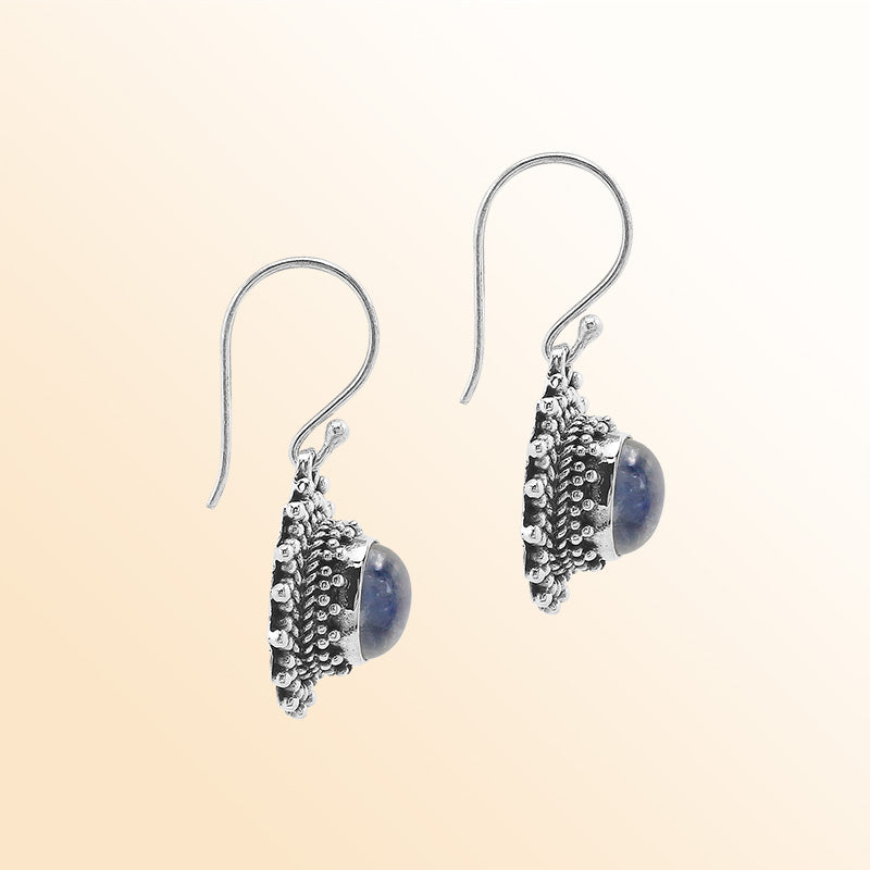 Sterling silver Bali granulated earrings featuring radiant rainbow moonstone cabochons and oxidized beadwork, created for individuals who value expressive, luminous, and artisan-crafted jewelry pieces.