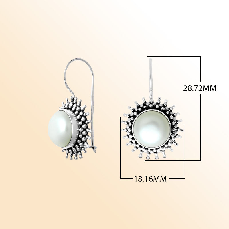 Sterling silver Bali granulated earrings featuring a luminous mabe pearl center framed with oxidized beadwork, created for individuals who appreciate expressive and beautifully handcrafted jewelry.