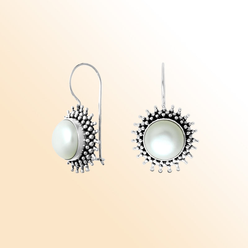 Sterling silver Bali granulated earrings featuring a luminous mabe pearl center framed with oxidized beadwork, created for individuals who appreciate expressive and beautifully handcrafted jewelry.