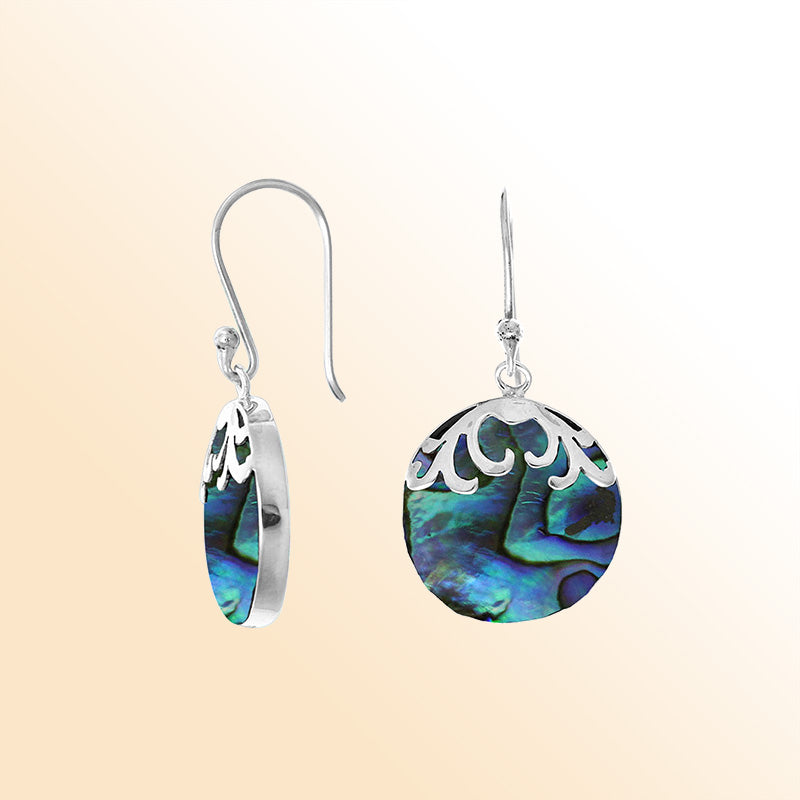 Sterling silver artisan earrings with abalone shell drops and flowing wave-style top.