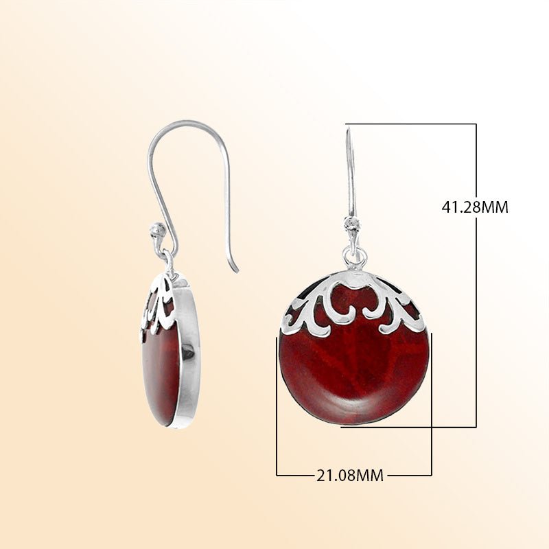Sterling silver artisan earrings with round red coral drops and flowing wave-style top.