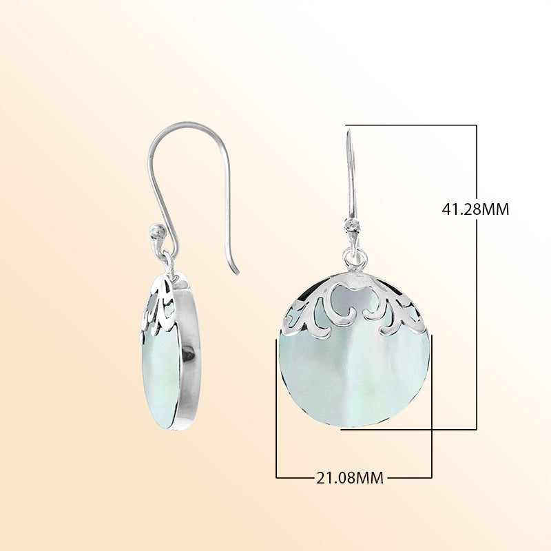 Beautiful sterling silver earrings featuring luminous round Mother of Pearl drops with detailed filigree accents and earwire hooks, handcrafted with artisan skill in Bali.