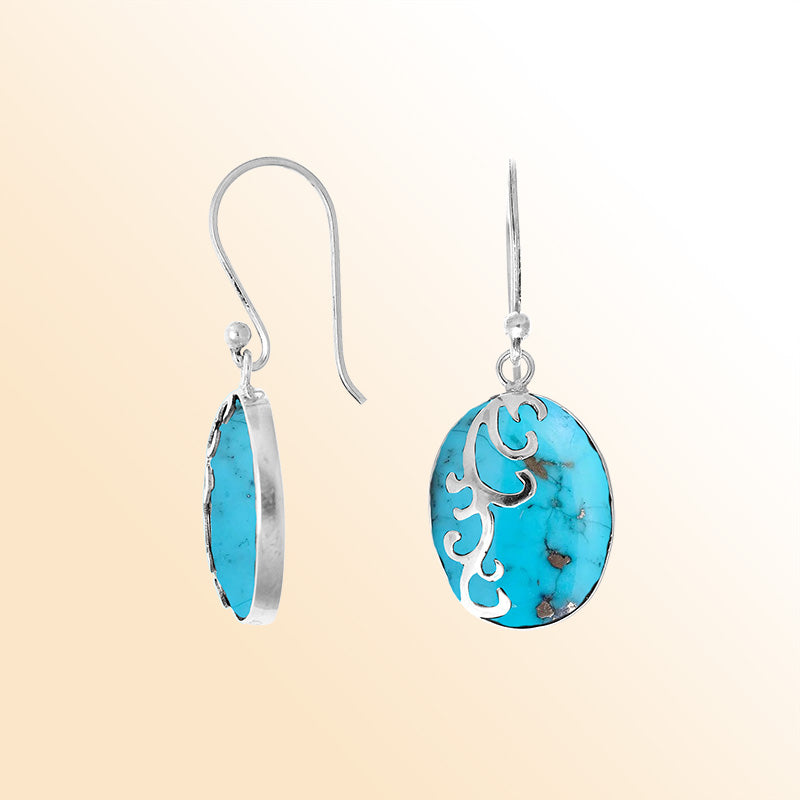 Sterling silver artisan earrings featuring vibrant turquoise shell ovals with a flowing wave-style overlay, designed to create a joyful ocean-inspired look for elegant everyday wear.