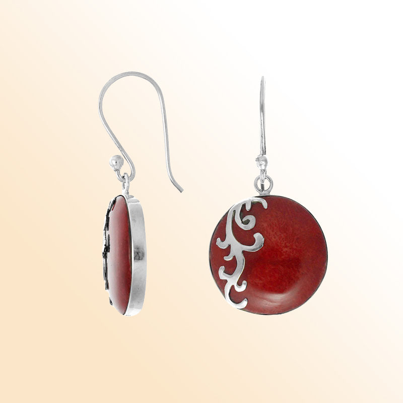 Sterling silver artisan earrings featuring round red coral with an elegant flowing wave-style overlay, designed to create an expressive ocean-inspired look for stylish everyday wear.