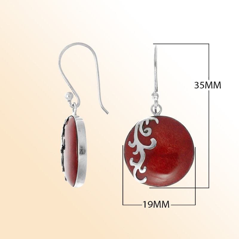 Sterling silver artisan earrings featuring round red coral with an elegant flowing wave-style overlay, designed to create an expressive ocean-inspired look for stylish everyday wear.