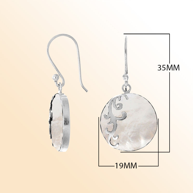 Sterling silver artisan earrings featuring luminous round mother of pearl with a flowing wave-style overlay, designed to evoke a serene ocean-inspired look for expressive, elegant everyday wear.
