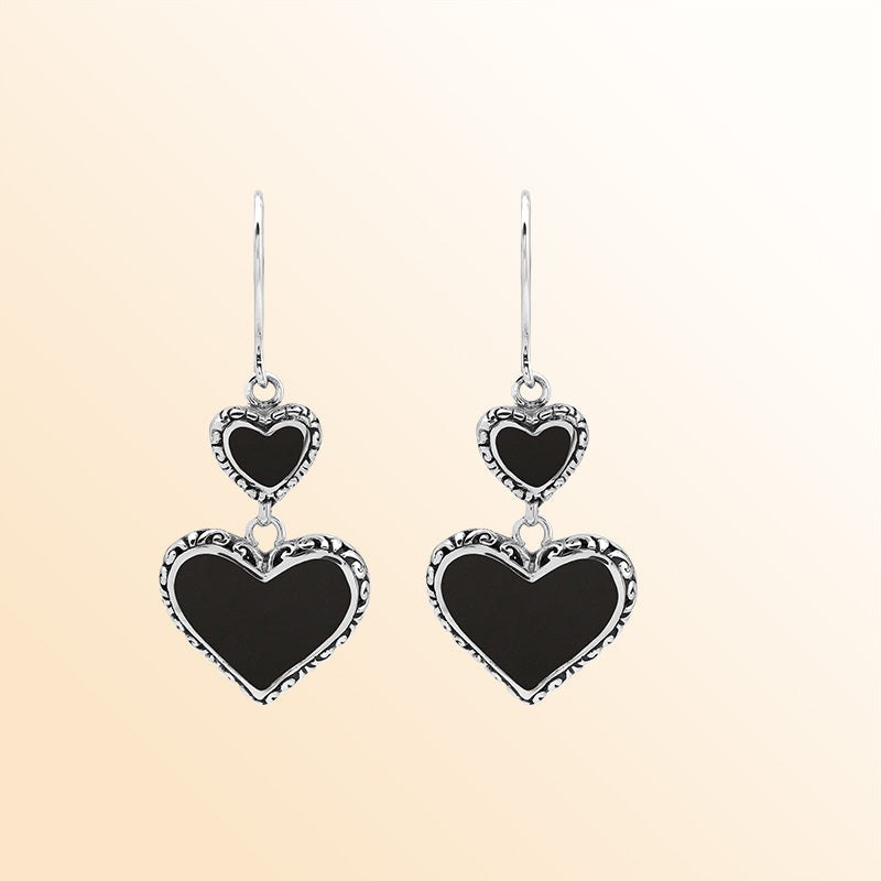Sterling silver artisan earrings featuring deep-toned black shell double hearts with ornate borders, designed to create an expressive romantic look for elegant and stylish everyday wear.