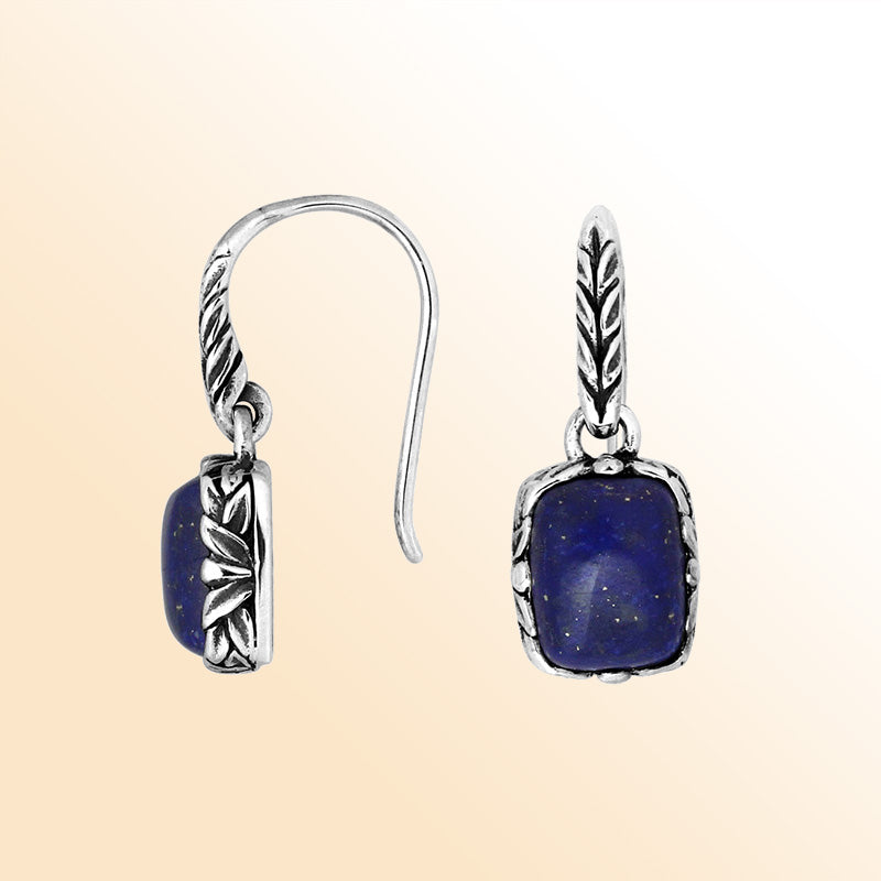 Elegant sterling silver earrings featuring a deep-blue Lapis cushion stone framed with carved silver detailing and earwire lock, offering a refined handcrafted aesthetic for expressive everyday wear.