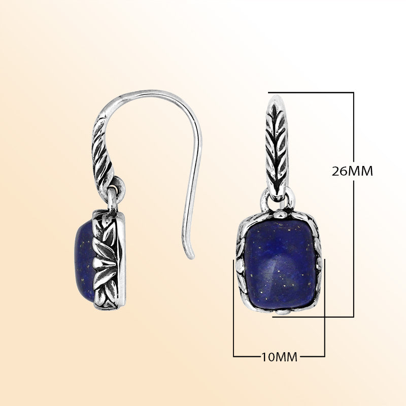 Elegant sterling silver earrings featuring a deep-blue Lapis cushion stone framed with carved silver detailing and earwire lock, offering a refined handcrafted aesthetic for expressive everyday wear.