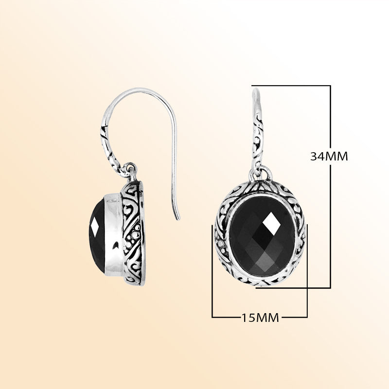 Sterling silver earrings featuring a faceted oval Black Onyx stone framed with ornate carved silver details and earwire lock, delivering bold contrast and handcrafted elegance for sophisticated everyday wear.