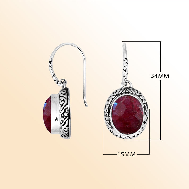 Sterling silver earrings featuring a vivid oval Ruby Quartz stone framed with ornate carved detailing and earwire lock, offering radiant color and handcrafted elegance suitable for stylish everyday wear.