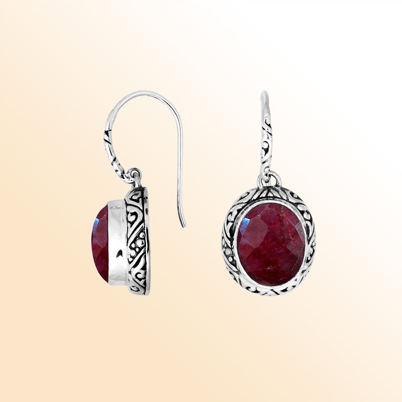 Sterling silver earrings featuring a vivid oval Ruby Quartz stone framed with ornate carved detailing and earwire lock, offering radiant color and handcrafted elegance suitable for stylish everyday wear.