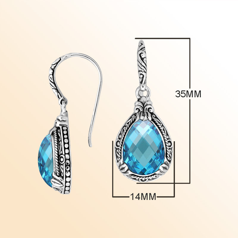 Sterling silver earrings featuring a radiant faceted Blue Topaz Quartz teardrop framed with ornate carved detailing and earwire lock, offering bright sparkle and handcrafted elegance for everyday wear.