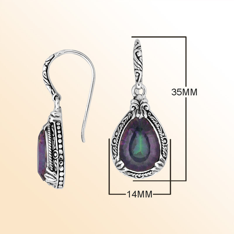 Sterling silver earrings featuring a prismatic Mystic Quartz teardrop displaying shifting purple and green tones, framed with ornate carved detailing and secured with an earwire lock for radiant handcrafted everyday elegance.