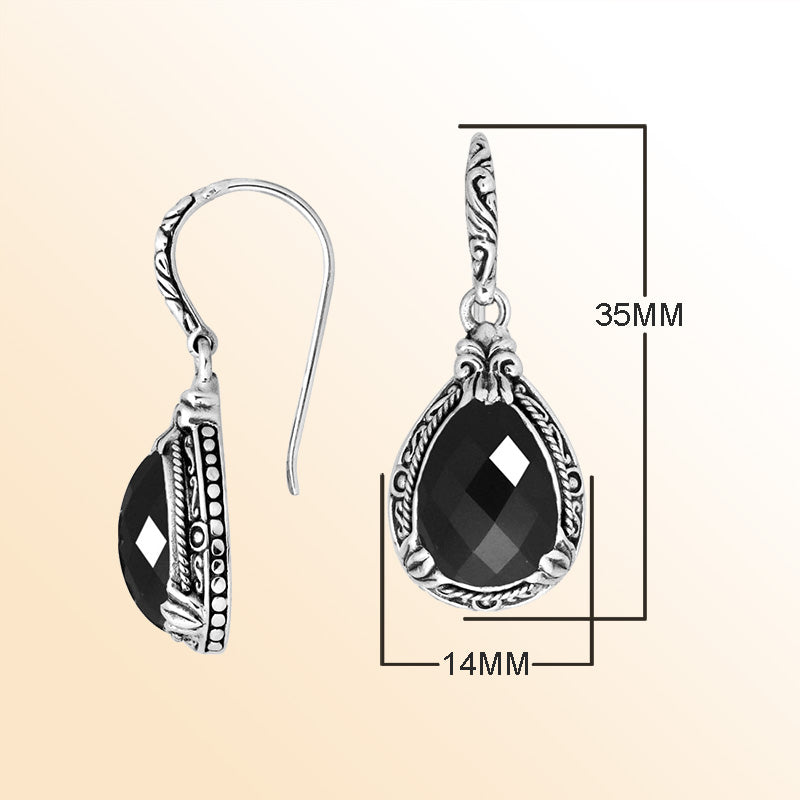 Sterling silver earrings featuring a striking faceted Black Onyx teardrop surrounded by artistic carved detailing and earwire lock, offering bold contrast and handcrafted contemporary elegance for expressive everyday wear.