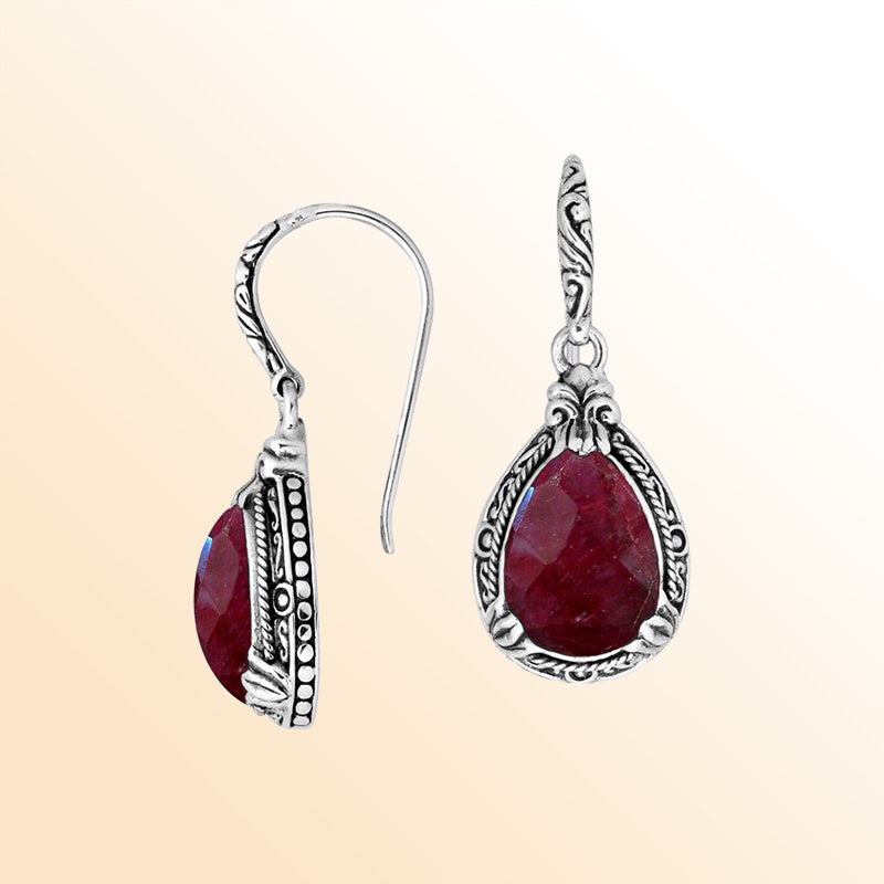 Sterling silver earrings featuring a warm, vibrant Ruby Quartz teardrop surrounded by expressive carved detailing and secured with an earwire lock, offering radiant handcrafted elegance for everyday wear.