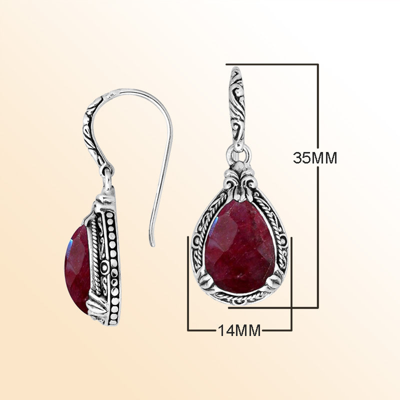 Sterling silver earrings featuring a warm, vibrant Ruby Quartz teardrop surrounded by expressive carved detailing and secured with an earwire lock, offering radiant handcrafted elegance for everyday wear.