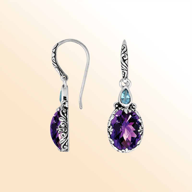 Sterling silver earrings featuring a radiant dual-stone pair of Amethyst Quartz and Blue Topaz Quartz with artistic carved detailing and earwire lock, created for colorful, expressive, handcrafted everyday elegance.