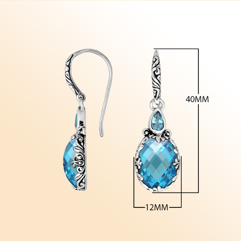 Sterling silver earrings featuring a sparkling faceted Blue Topaz Quartz teardrop surrounded by artistic carved borders and secure earwire lock for bright, refreshing everyday elegance.