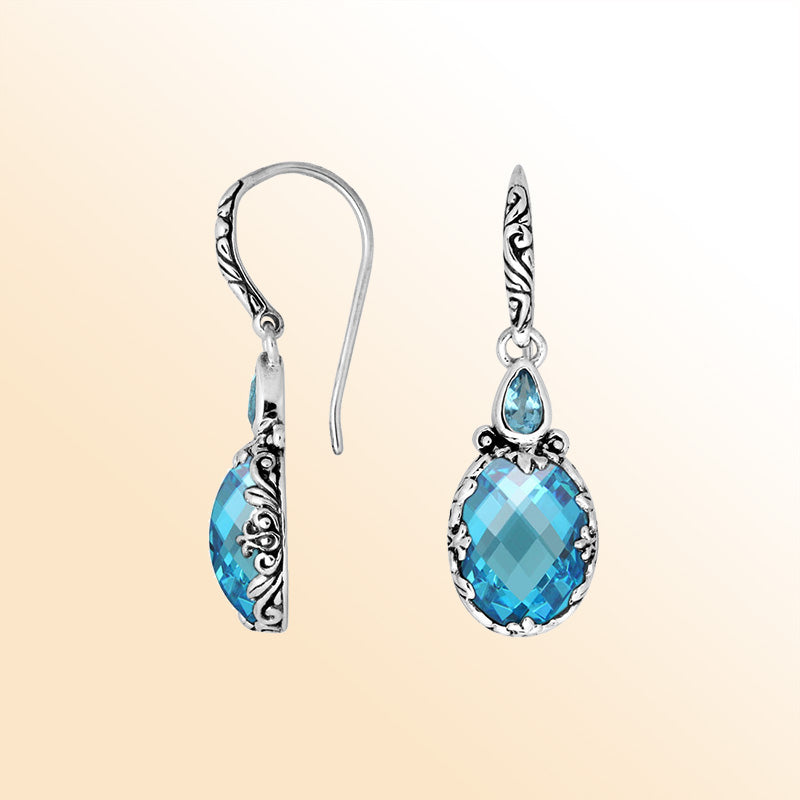 Sterling silver earrings featuring a sparkling faceted Blue Topaz Quartz teardrop surrounded by artistic carved borders and secure earwire lock for bright, refreshing everyday elegance.