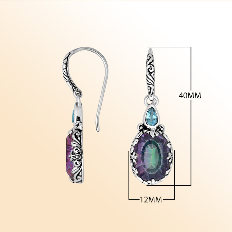 Sterling silver earrings featuring a color-shifting Mystic Quartz oval paired with a sparkling Blue Topaz Quartz accent, enriched with artistic carved borders and earwire lock for radiant handcrafted everyday elegance.